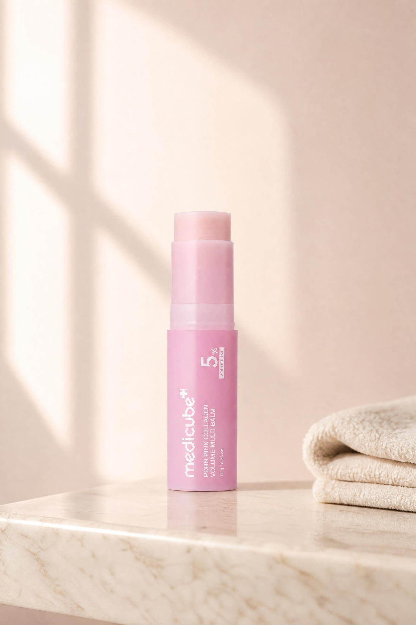 The balm stick on a marble bathroom ledge in morning light