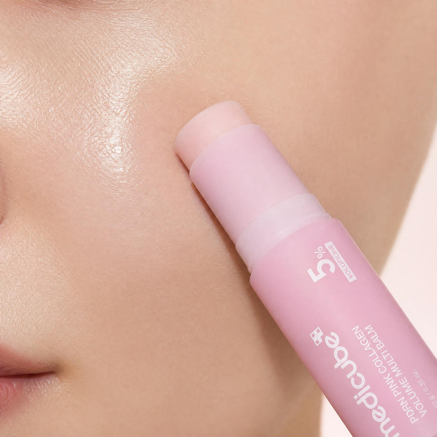 The balm being glided across the cheek and under-eye area